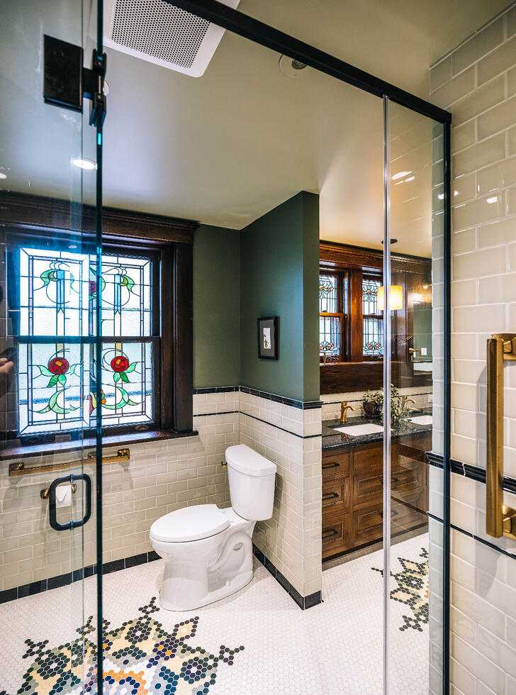 tile bathroom with stained glass window
